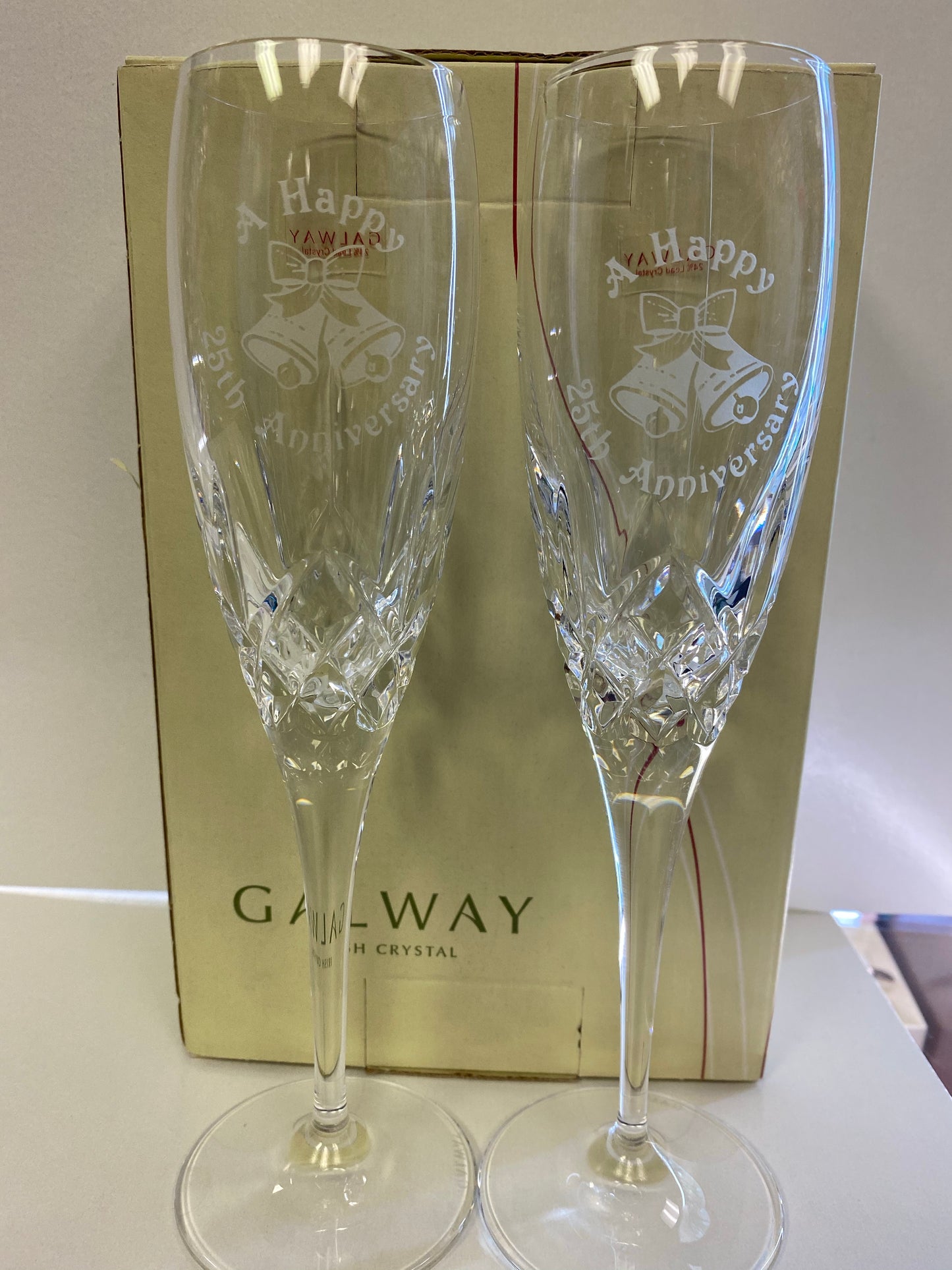 A happy 25th anniversary toasting flutes